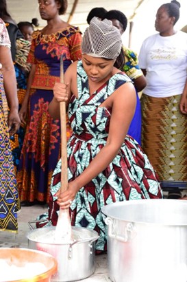 A woman stirring a big pot.